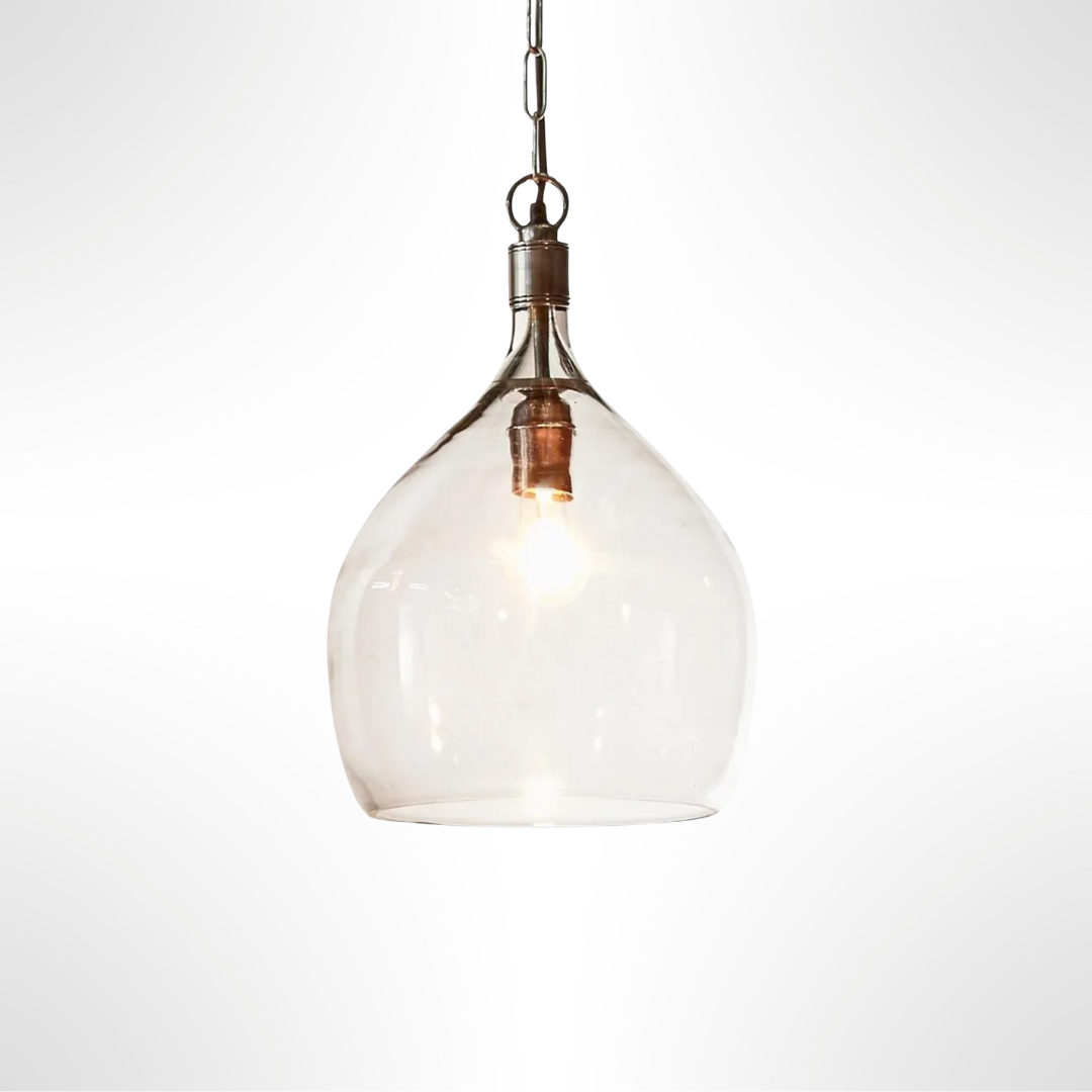 Clear glass pendant light with silver fixture on a white background
