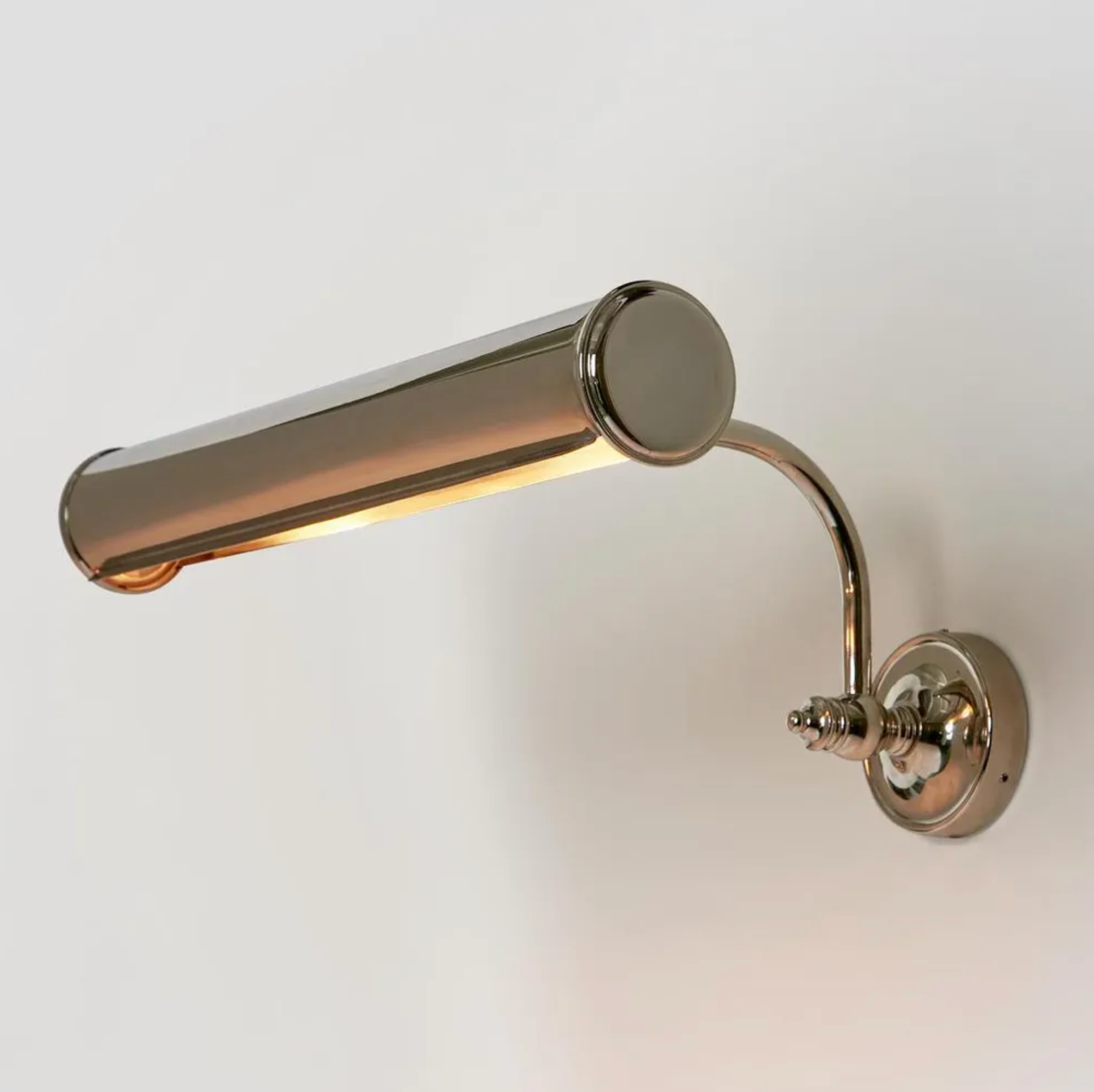 Nickel wall-mounted lamp on a plain background