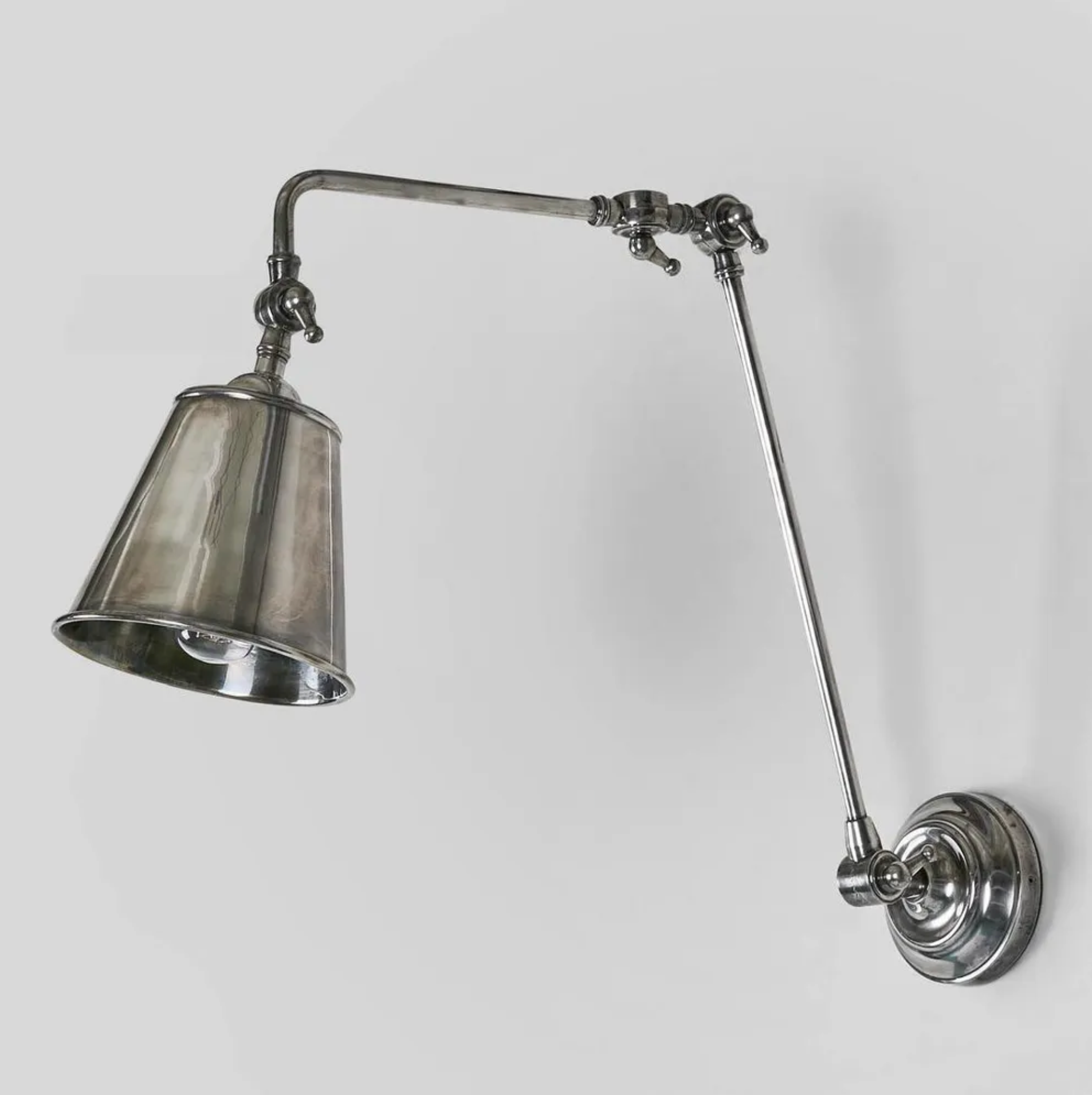 Vintage-style wall lamp with adjustable arm on a light gray background