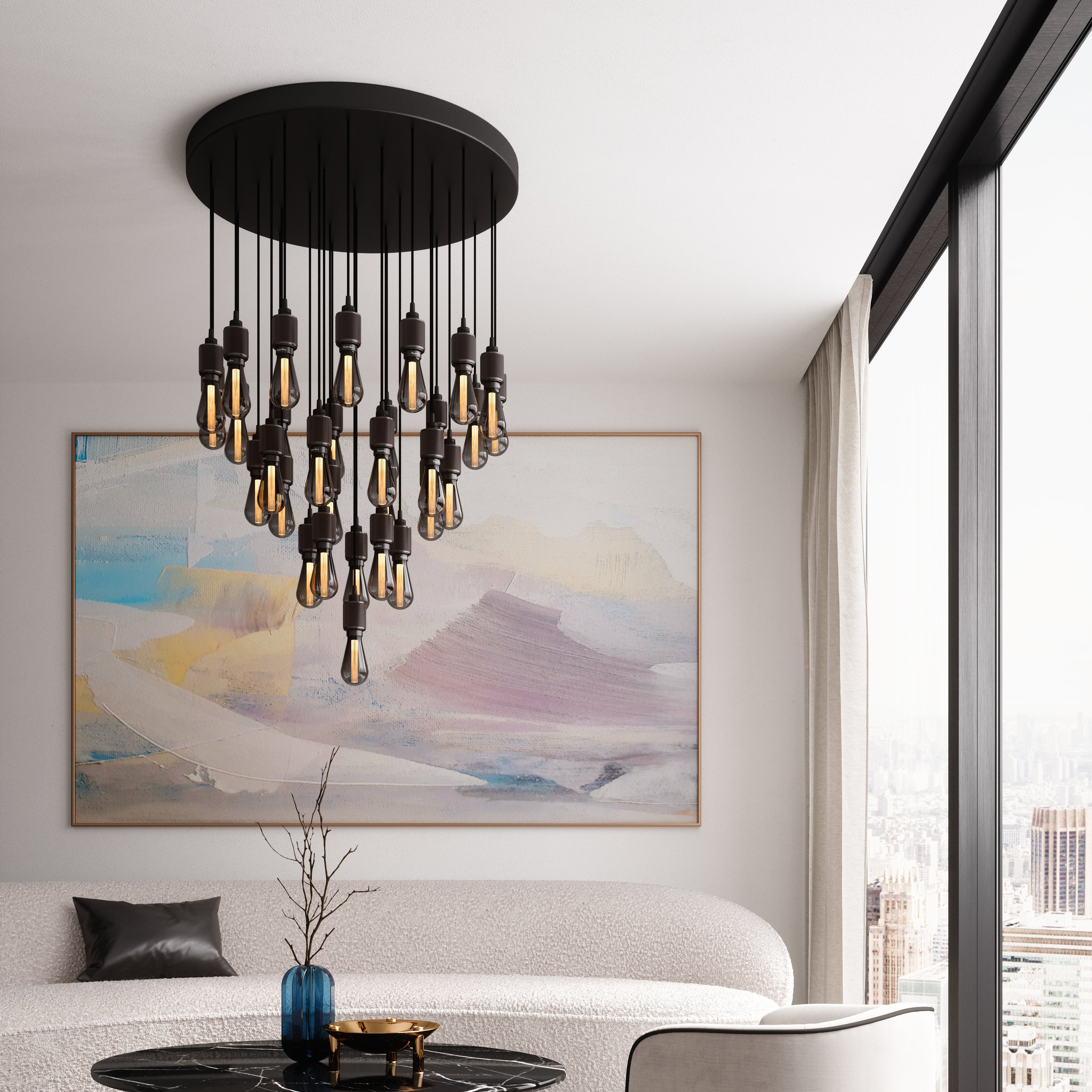 Modern living room with a stylish chandelier, sofa, and abstract painting.
