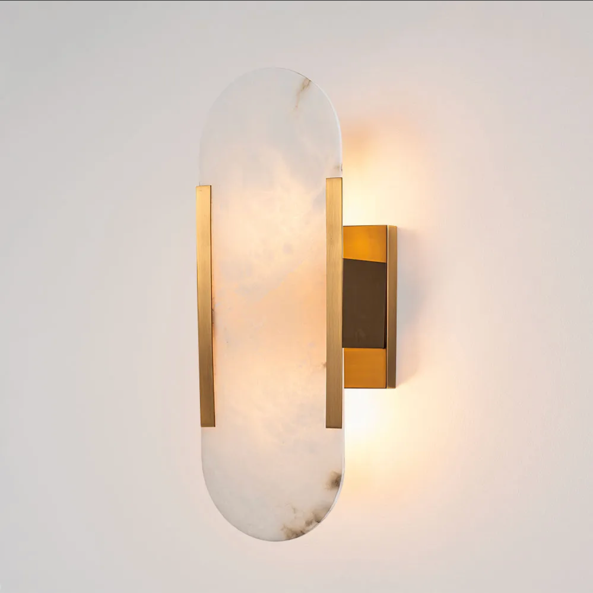 Modern wall sconce with gold and marble design on a white background