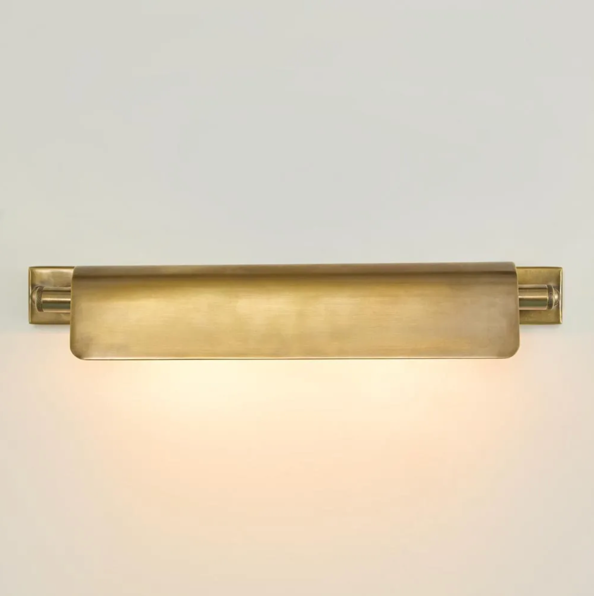 Brass wall sconce on a light gray background