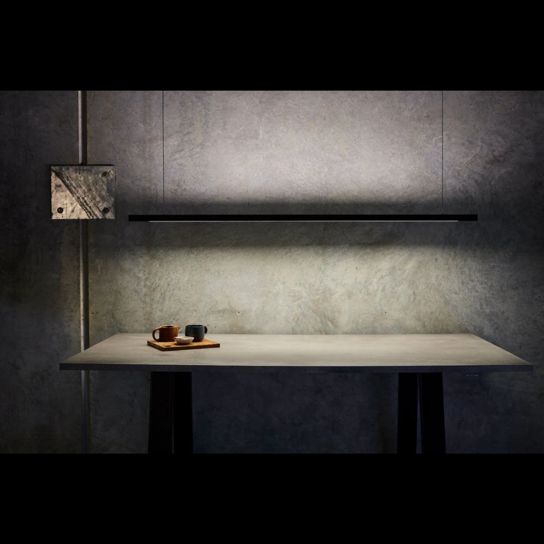 Black linear light on and a table with a tray on a concrete wall background.