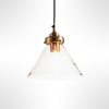 Pendant light with brass fixture and clear glass shade on a white background
