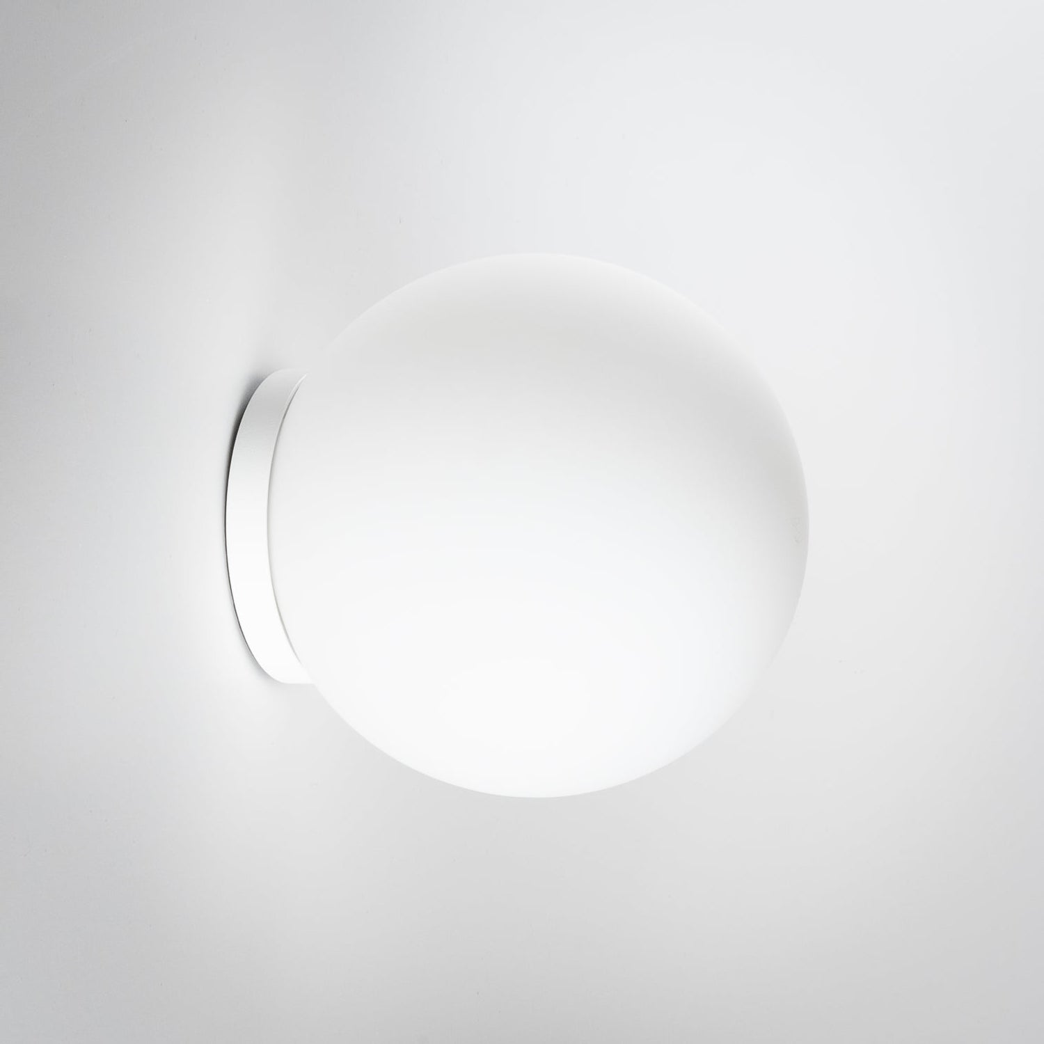 White spherical wall light fixture on a white background