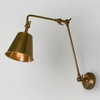 Antique Gold wall lamp with adjustable arm on a light gray background