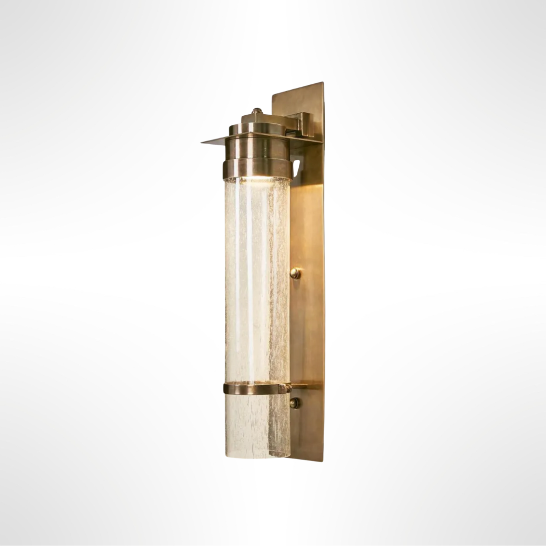 Brass wall sconce with glass shade on a white background