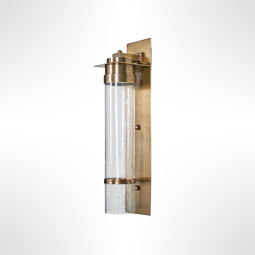 Brass wall sconce with clear glass on a white background