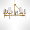 Gold chandelier with white lampshades on a white background