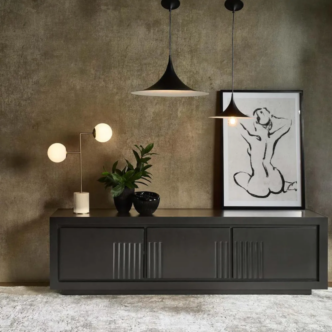 Modern interior with a black console table, , two black sophia pendant lights, decorative plant, and framed artwork against a textured wall.