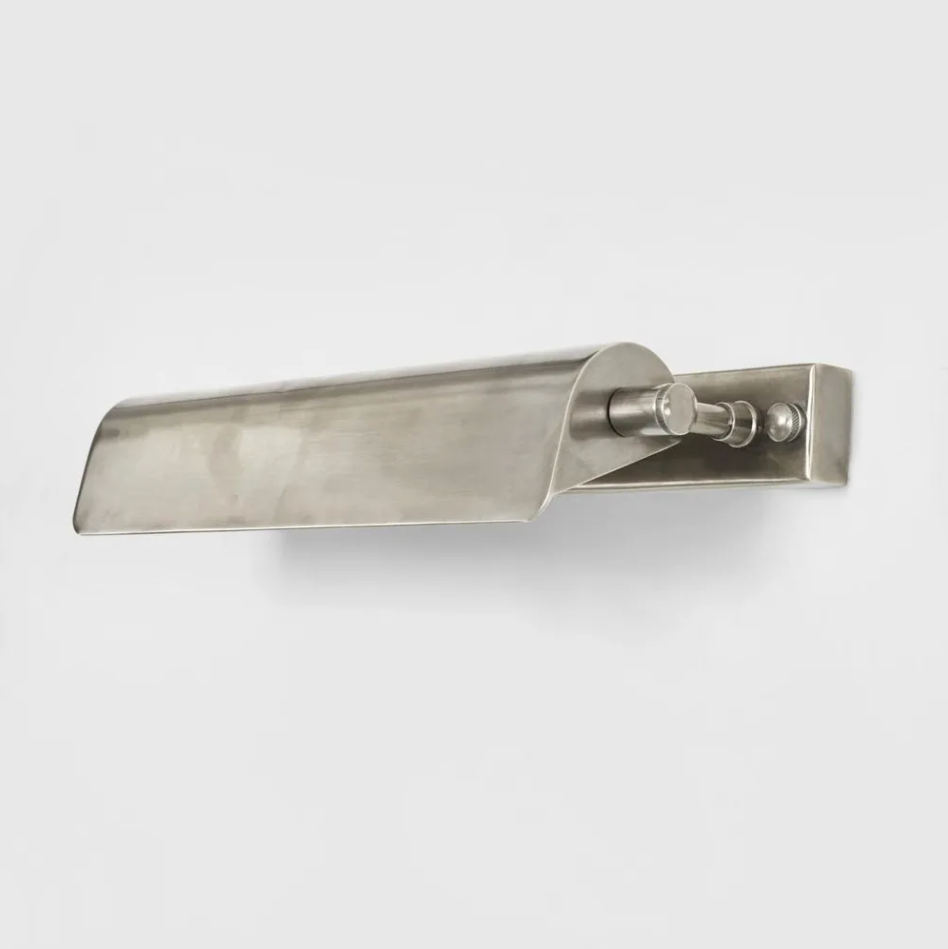Metallic wall sconce on a white background