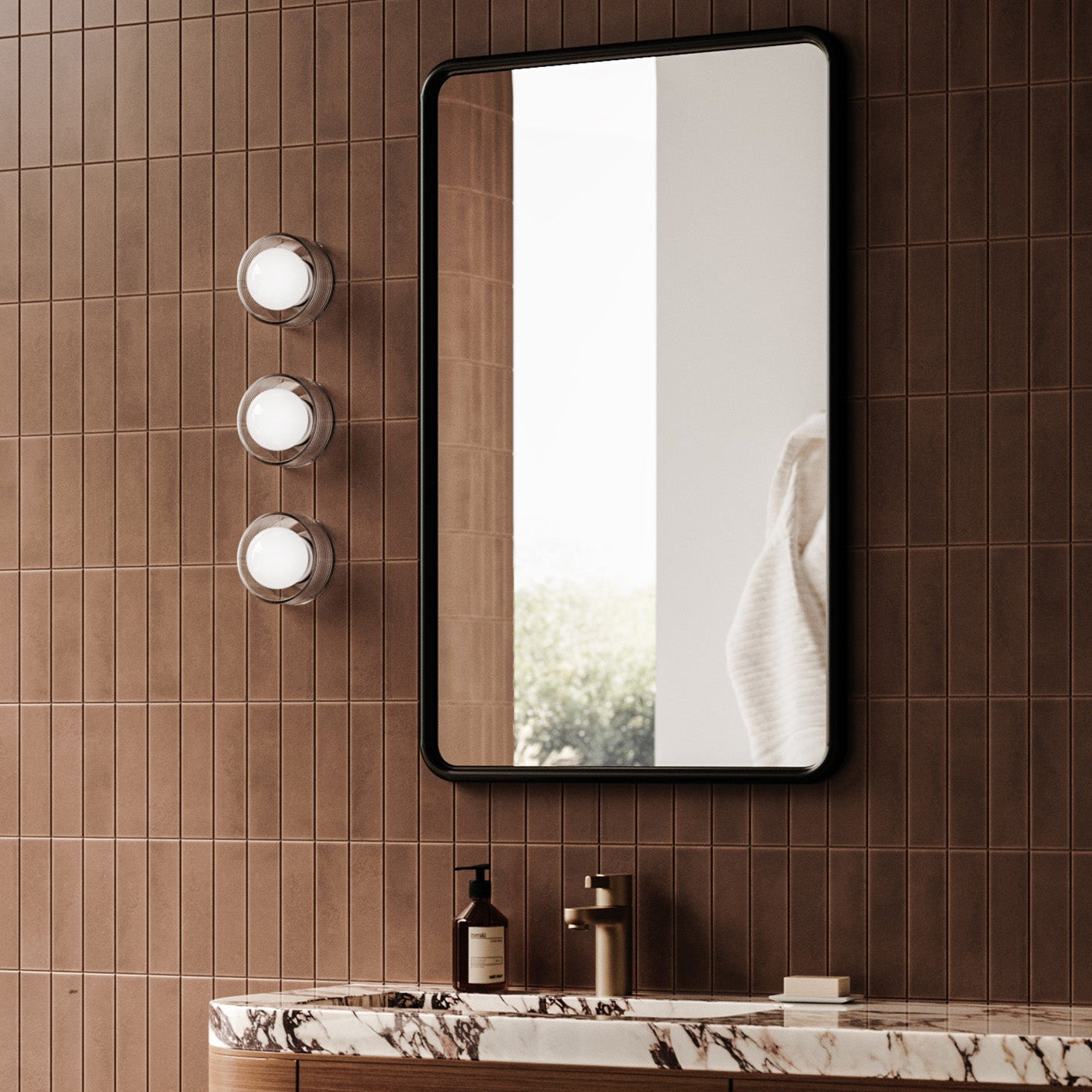 Bathroom vanity with mirror and lights on a tiled wall